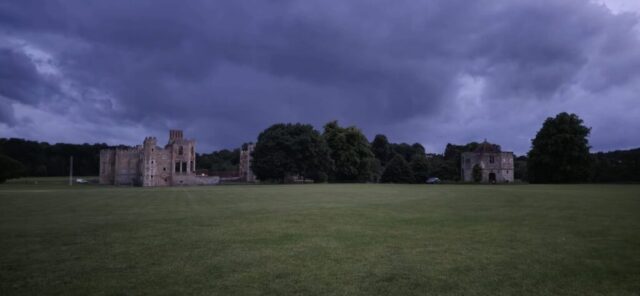 Evening storm building over Cricket outfield and Cowdray Ruins.